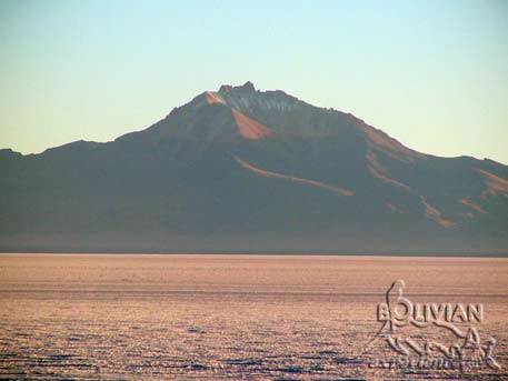 Volcano Tumupa (5250m - 17220f) early in the morning towering over Salar de Uyuni, Bolivia