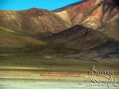 The Calama – Uyuni train running along Salar de Chiquani below Mt. Chuguana, Bolivia